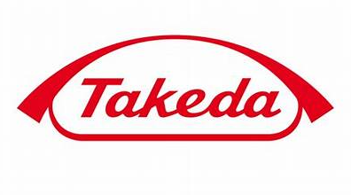 A red and white logo of takeda.