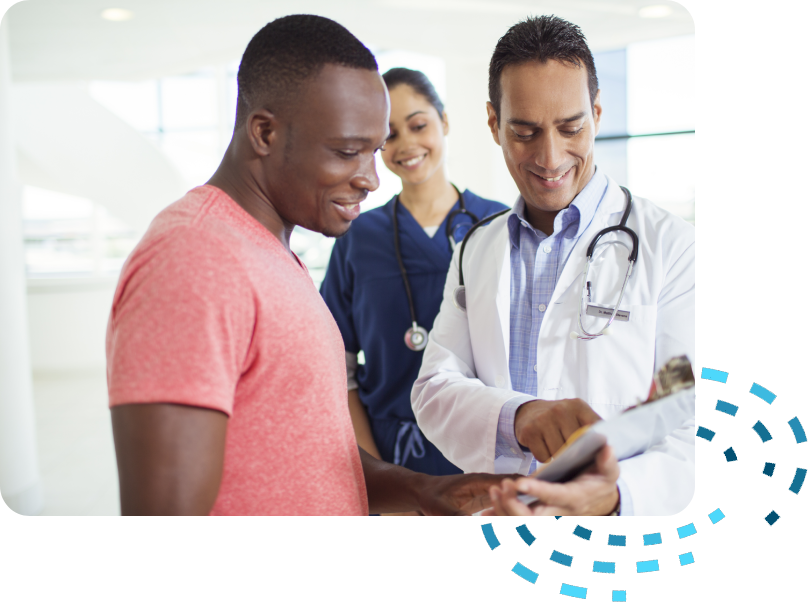 A doctor showing a patient something on his phone.